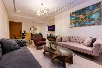 a living room with two couches and a table at Homerest appartement Casablanca in Casablanca