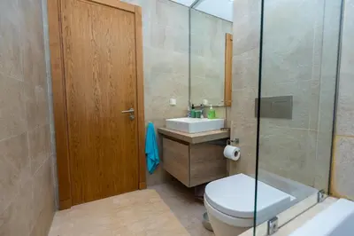 a bathroom with a toilet and a sink and a shower at Homerest appartement Casablanca in Casablanca