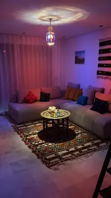 a living room with a couch and a table at Terrace Solarium & Fitness & Berber Tradition in Casablanca