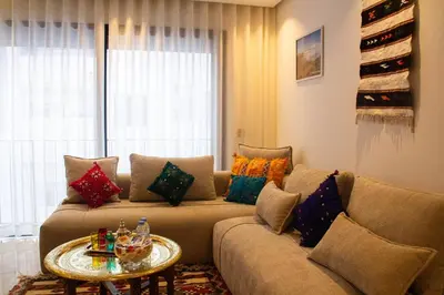 a living room with a couch with colorful pillows at Terrace Solarium & Fitness & Berber Tradition in Casablanca