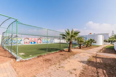 a batting cage with a mural on the side of a building at Villa Zen, piscine privée et plage in Casablanca