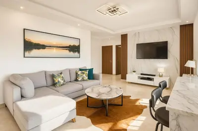 a living room with a couch and a table at Jolie appartement bord de mer de standing in Mohammedia