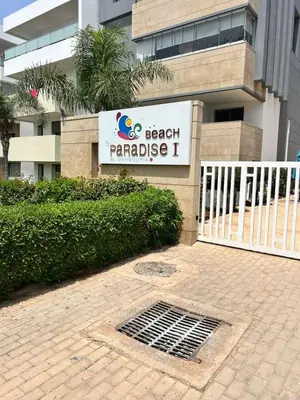 a beach paradise sign in front of a building at Beautiful Family Apartment Beach Paradise Residence in Pont Blondin