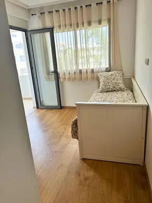 a bedroom with a bed and a large window at Beautiful Family Apartment Beach Paradise Residence in Pont Blondin