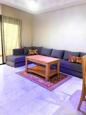 a living room with a blue couch and a coffee table at Charming Apartment Residence Ocean Park Pool, Sea in Aïn Harrouda