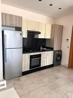 a kitchen with a stainless steel refrigerator and a dishwasher at Beautiful Apartment Residence Miramar Sea View in Mohammedia
