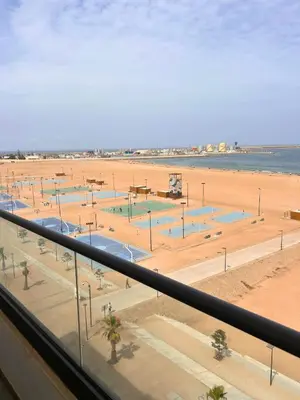 a view of a beach from a balcony at Beautiful Apartment Residence Miramar Sea View in Mohammedia