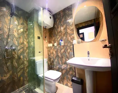 a bathroom with a shower and a toilet and a sink at Modern Apart Heart of Casablanca Perfect Location in Oulad Akkou
