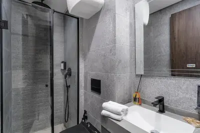 a bathroom with a sink and a shower at The Nest Residence by GoodMove - Gauthier Casablanca in Casablanca