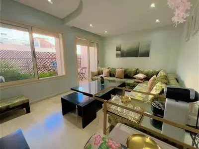a living room with a couch and a table at Casa Stay in Casablanca
