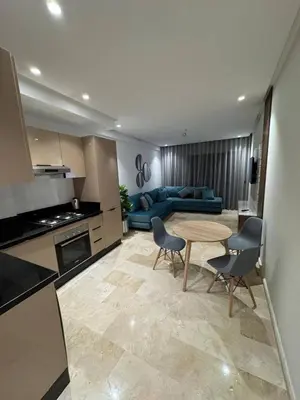 a kitchen and living room with a table and a couch at Studio de lux in Casablanca