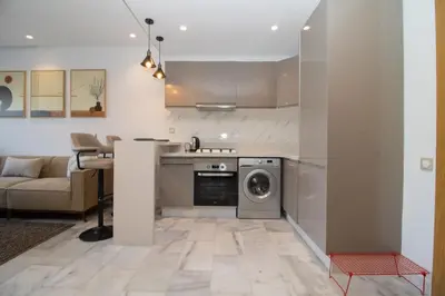 a kitchen with a washer and dryer in a room at Studio Palmier Casablanca in Maarif