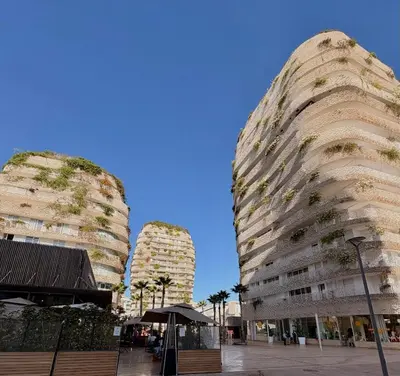 two tall buildings with plants growing on them at Smile City Homes in Casablanca