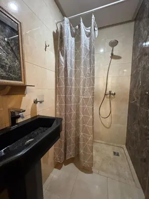 a bathroom with a shower with a shower curtain at bel appartement in Temara