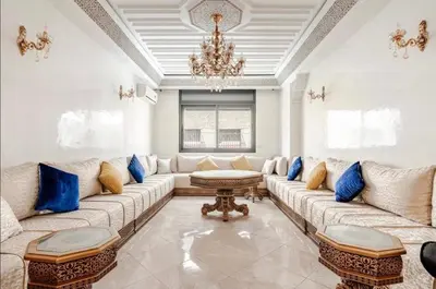 a large living room with a large couch and blue pillows at luxury apartment in casablanca in Maarif
