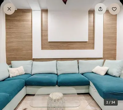 a living room with a blue couch and a frame at luxury apartment in casablanca in Maarif