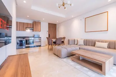 a living room with a couch and a table at Cozy Studio with Pool & Parking in Aïn Harrouda