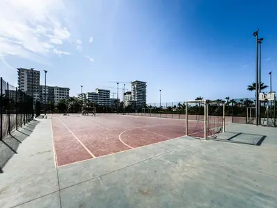 a tennis court with a net in a city at Cozy Studio with Pool & Parking in Aïn Harrouda