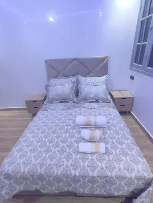 a bedroom with a large bed with two towels on it at Ferme royale Bensliman in O Ben Slimane