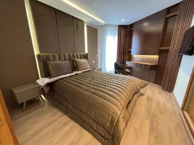 a bedroom with a large bed and a desk at Corniche Casablanca - Kimberly Luxury Suite in Casablanca