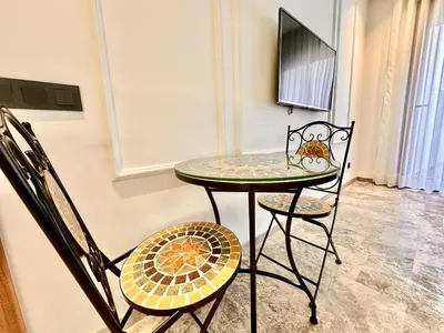 a small table and two chairs in a room at Calm Studio in Oasis, Near Train Station in Casablanca