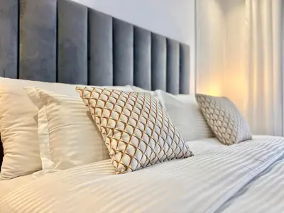 a bed with white sheets and pillows on it at Calm Studio in Oasis, Near Train Station in Casablanca