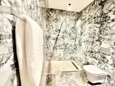 a black and white bathroom with a toilet at Cozy, Elegant Apartment, Parking and Fiber in Casablanca