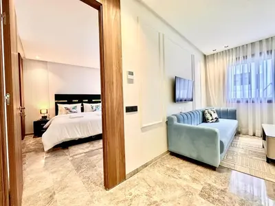 a bedroom with a bed and a mirror at Oasis Studio - Parking, Fiber, Near the Station in Casablanca