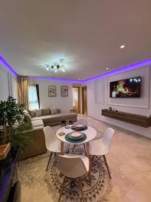 a living room with a table and chairs and a couch at Modern Studio France ville in Casablanca