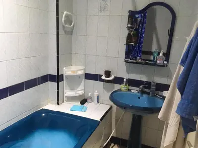 a bathroom with a blue tub and a sink at Appartement Familial Emile Zola in Casablanca