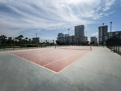 a tennis court in the middle of a city at Modern Apartment Pool Balcony & Comfort in Aïn Harrouda