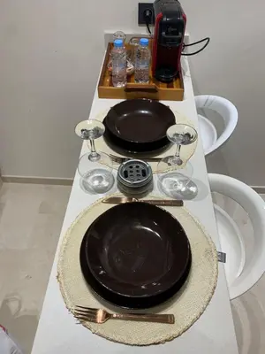 a table with two black plates and a tea kettle at Castilo in Casablanca