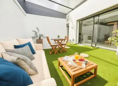 a living room with a white couch and a table at MAYA SUITES - Corniche Seaside in Casablanca