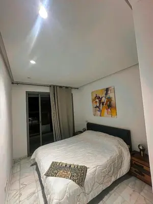 a bedroom with a white bed and a window at Studio de luxe, lumineux et parfait in Casablanca