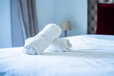 a pile of towels sitting on a bed at C07- Pestana - Luxury Hotel Flat - Terrace - Pool in Casablanca