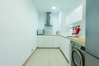 a white kitchen with a washing machine in it at C07- Pestana - Luxury Hotel Flat - Terrace - Pool in Casablanca