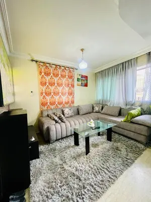 a living room with a couch and a table at Résidence in Casablanca