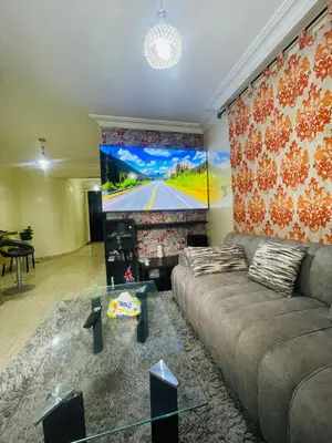 a living room with a couch and a flat screen tv at Résidence in Casablanca