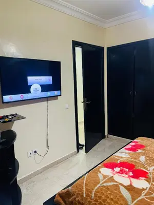 a bedroom with a flat screen tv on the wall at Résidence in Casablanca
