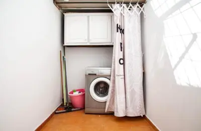 a laundry room with a washing machine and a window at Appartement à agdal 2 chambres in Rabat