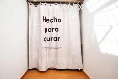 a white curtain in a room with a window at Appartement à agdal 2 chambres in Rabat