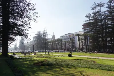 a park with benches and trees in a city at Charming Modern Studio near Corniche Mohammedia in Mohammedia
