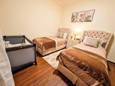 a bedroom with two beds and a crib at Seaside 3 bedrooms apartment in Mansouria near Sablette Beach Mohammadia in Pont Blondin