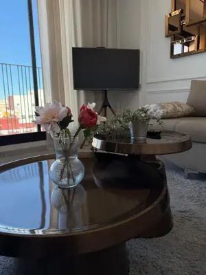 a living room with a table with flowers on it at Metropoleparc luxury apparthotel in Casablanca