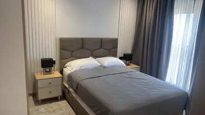 a bedroom with a large bed with two night stands at Metropoleparc luxury apparthotel in Casablanca