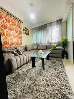 a living room with a couch and a table at Résidence Adam in Casablanca