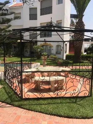 a gate with a table in front of a building at Apartment in a waterfront complex in Casablanca