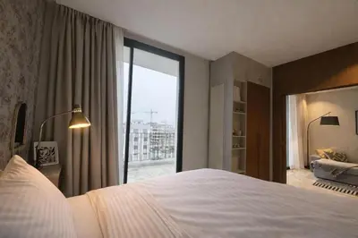 a bedroom with a large bed and a large window at Cedar Stays Appartement 1 chambre salon, parking, climatisation, Wifi, balcon in Casablanca