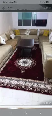 a living room with a couch and a coffee table at Appartement ville des roses in Mohammedia