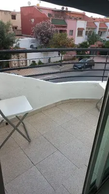 a white bench sitting on top of a balcony at Appartement ville des roses in Mohammedia